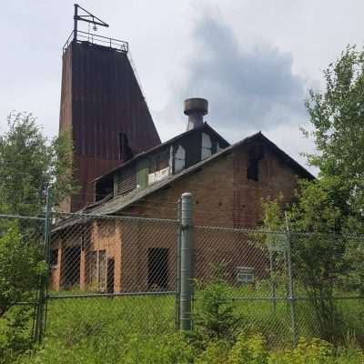 An old mine with mine shaft and building off Gibbs City Road. Locked up but you can see a lot of equipment laying around still.