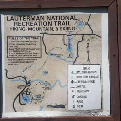 The sign shows the trail goes past lost lake, Spruce Lake Pine River Overlook