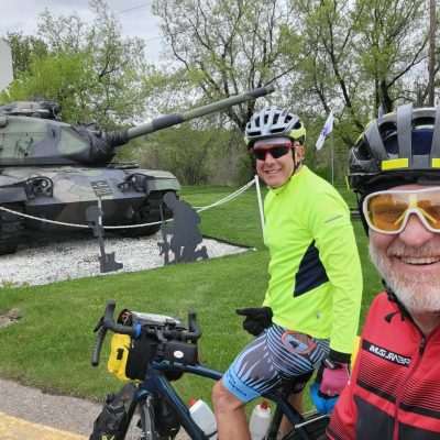 Posers at the Tank in Caspian MI. We are just finishing a long bike tour from Denver to Iron River. About 14 miles more to go, 1550 miles total. Brady Ave and Caspian Ave.