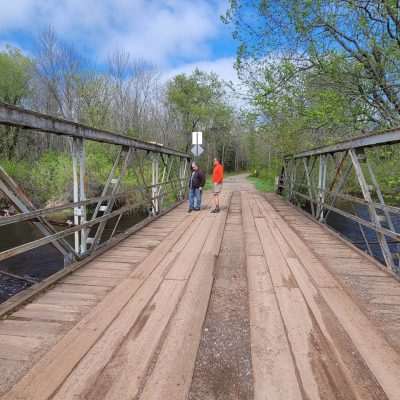 The old bridge on Pentoga Road National Forest Road 2446. This is the last standing bridge for a long time crossing the Brule for many miles up and down river. Every spring is comes under attack from floods. In 2023 the river came to the top and overflowed a new segment on Wisconsin side.