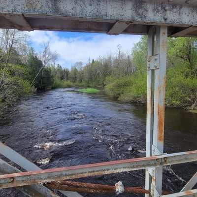 The old bridge on Pentoga Road National Forest Road 2446. Brule river is historic and was used in the early 1900 to ferry logs to the Pentoga Log Mill just above this bridge. The Logs were stored and then floated down the Brule in the spring flood to the mill. Old Pentoga was a Lumber town, and had many of the same company houses and church and school and hotel.