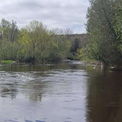 Wide shot from an upriver point on the Brule River looking back at the Pentoga Road Bridge separating Michigan from Wisconsin.