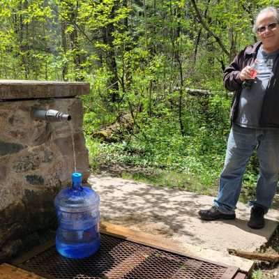 At the Artesian spring in Wisconsin next to the Pine River getting spring water.