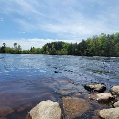 Looking Down River on the Menomonee River next to Ford Airport in Iron Mountain. This river is the division between Wisconsin on the far side and Michigan on this side just like the Brule River. The Brule river combines with the Paint River, then combines with the Michigamme River and they all combine to make the Menominee River. The Menominee River will continue to the Great Lake Michigan at Marinette Wisconsin and Menominee Michigan. They are both the same town north of Green Bay on Green bay divided by the Menominee river.