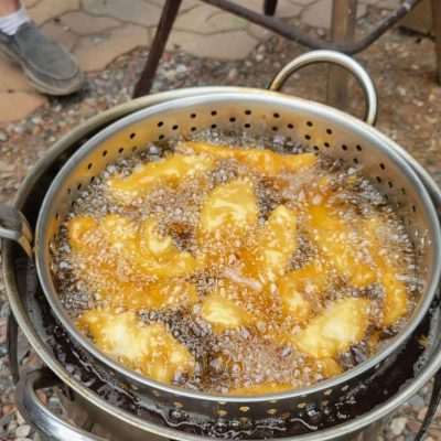 Beer batter walleye fish fry in oil outside fueled by a propane flame. It was very good.