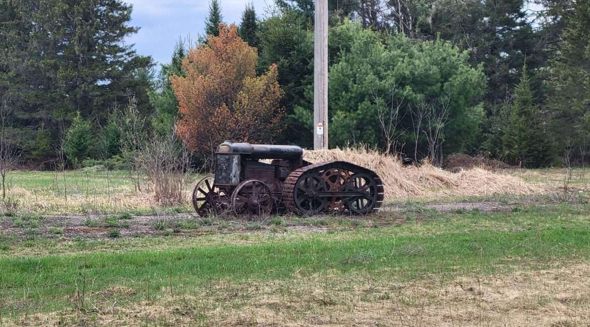 This old tractor was outside in Northern Wisconsin near Eagle River. The back tracks and gears are interesting.