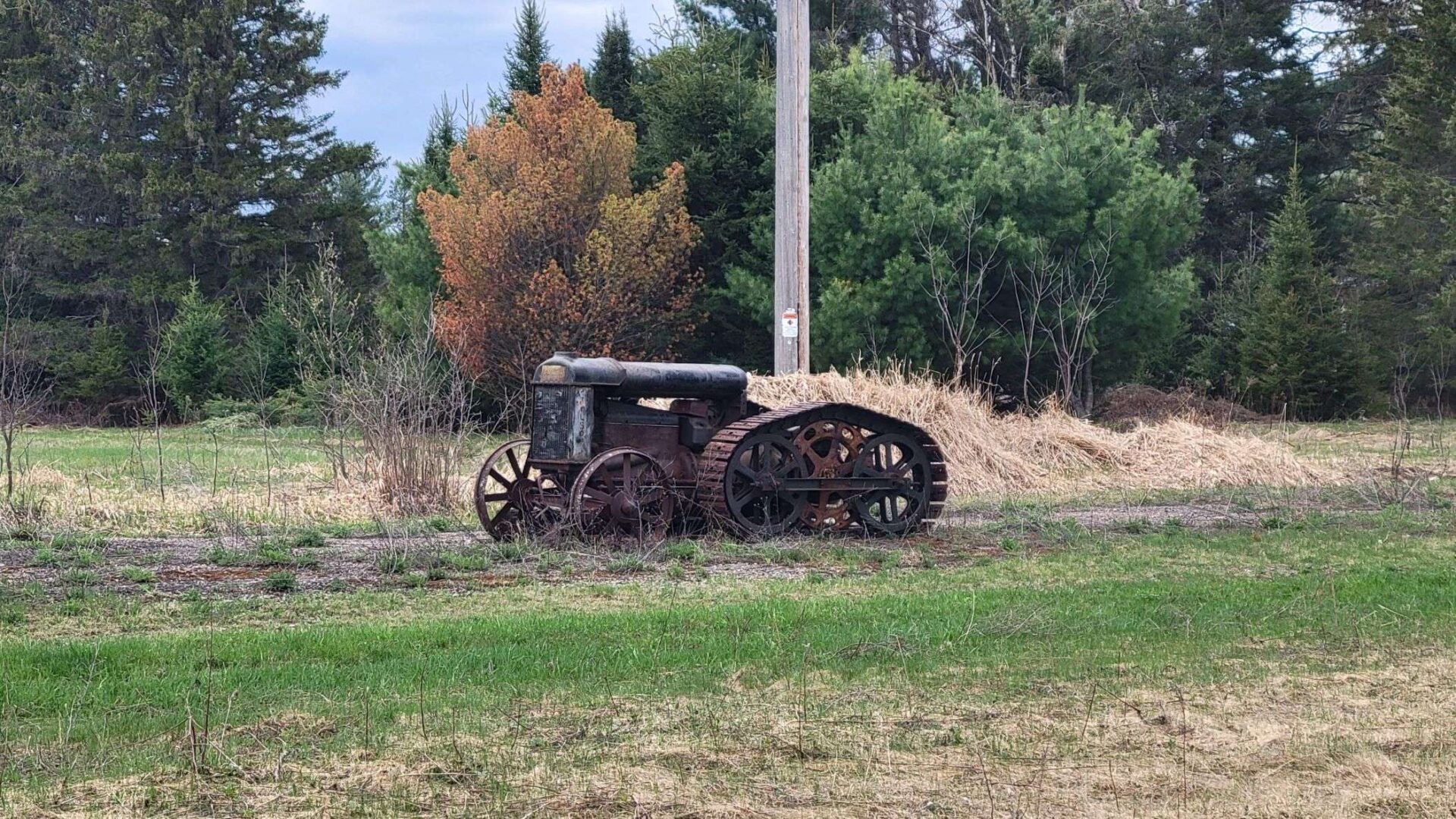 This old tractor was outside in Northern Wisconsin near Eagle River. The back tracks and gears are interesting.
