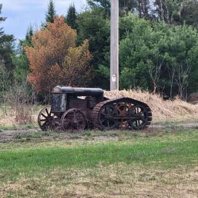 This old tractor was outside in Northern Wisconsin near Eagle River. The back tracks and gears are interesting.