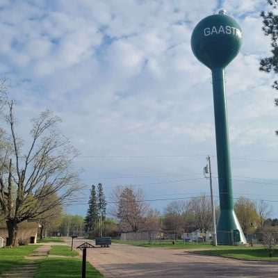 The Gaastra Water Tower in looking good 2023 with new paint. Next to the water tower is a sweet old playground with some old time playground equipment.