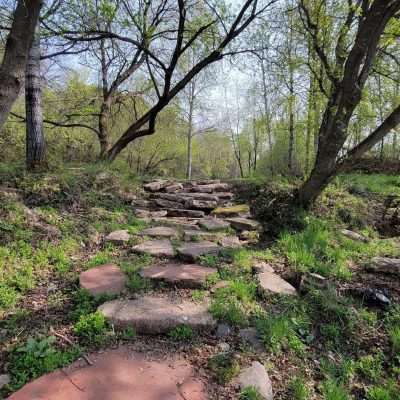 Stone walking path up hill at the Frisbee Golf course in Iron River on the Apple Blossom Trail.