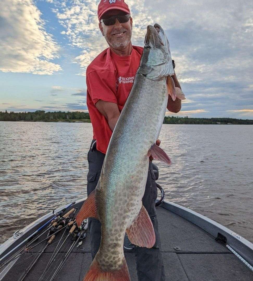 Man holding large fish on boat