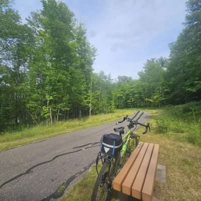 Bicycle on bench near forest trail