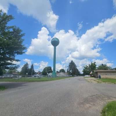 Amastra water tower in small town neighborhood