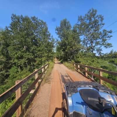 ATV riding on scenic trail with river view