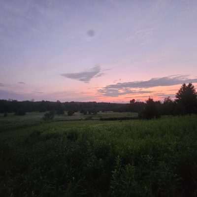 Beautiful meadow at sunset with colorful sky.