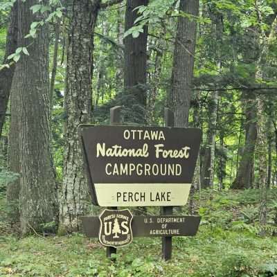 Ottawa National Forest campground sign in woods.