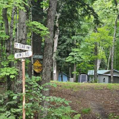 Forest road signs and cabins in the woods.