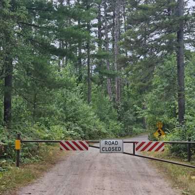 Road closed gate in a forest trail