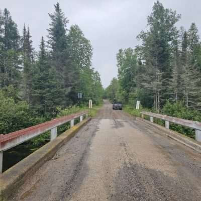 Rustic bridge leading to a forested dirt road in the U.P.