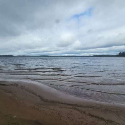 Cloudy sky over a tranquil lake beach