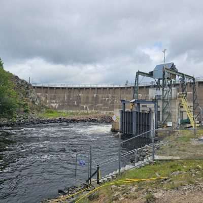 Way Dam Hydroelectric dam with surrounding nature and cloudy sky.