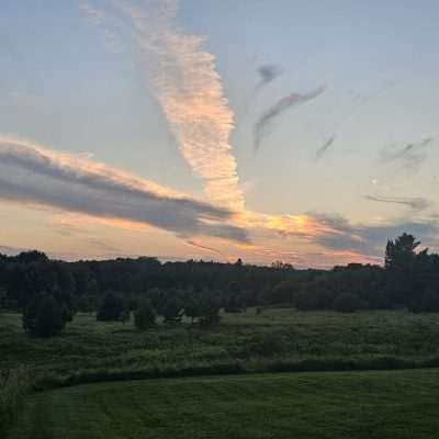 Sunset over a lush green field in Old Pentoga U. P. Michigan.