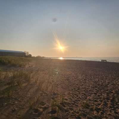 Lake Superior from Ontonagon Sunset over a sandy beach with grass.