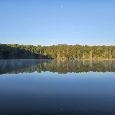 Moon and mirror on calm waters at Camp Three Lake in Northern Wisconsin