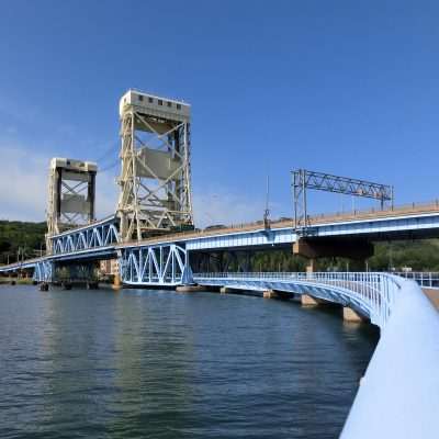 Lift bridge over a river with blue sky.